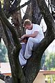 kellan lutz climbs tree reads book 24