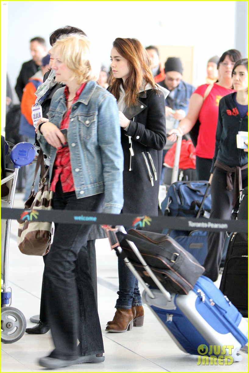 lily collins jcb separate toronto departures 02