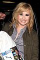 demi lovato brings her i love ellen pillow to the airport 01