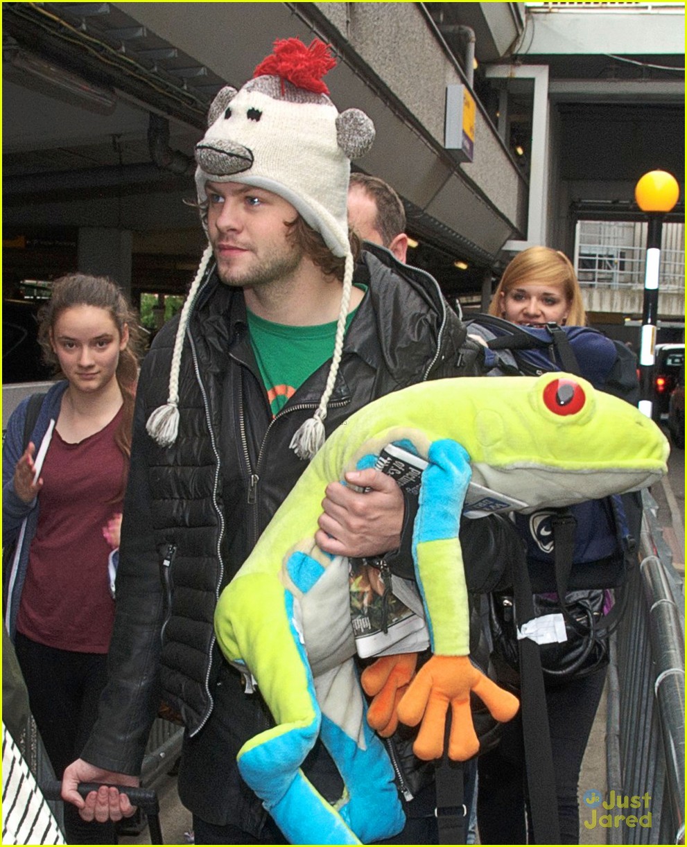 the wanted jay mcguiness carries froggy friend at the airport 07