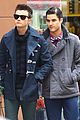 darren criss leans on chris colfer while filming glee 02