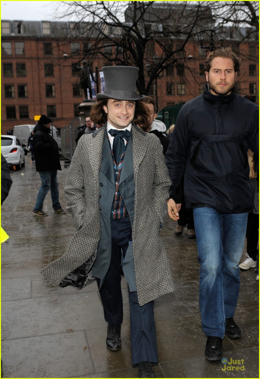daniel radcliffe covers long hair with topper hat 03