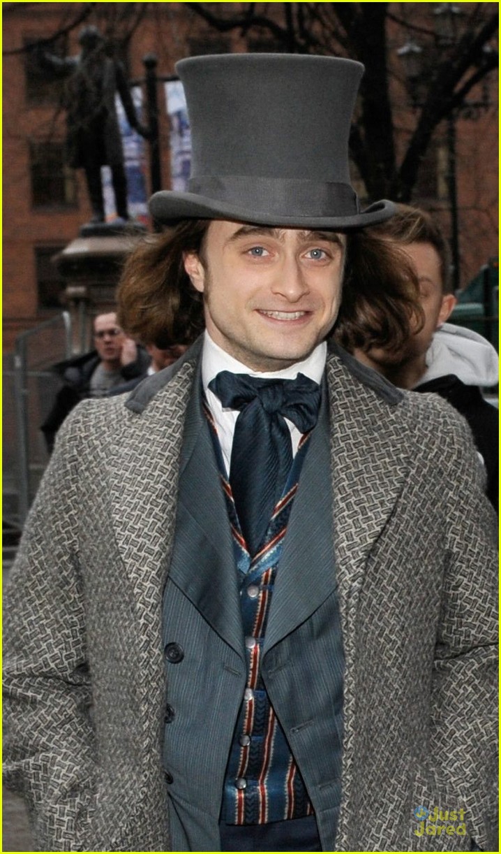 daniel radcliffe covers long hair with topper hat 04