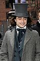 daniel radcliffe covers long hair with topper hat 05