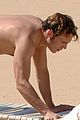 sam claflin shirtless at the beach 06