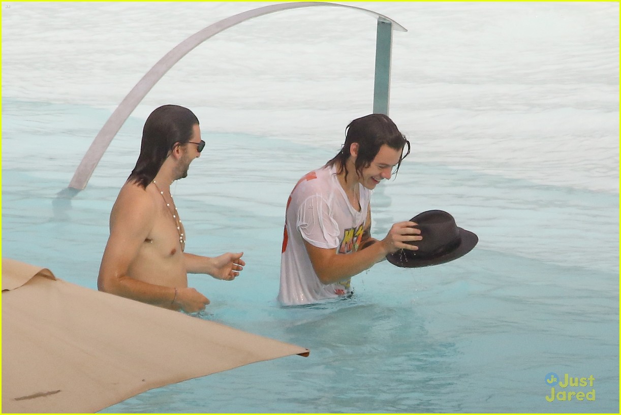 harry styles shirtless rio tossed in pool 08