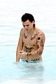 harry styles shirtless rio tossed in pool 10