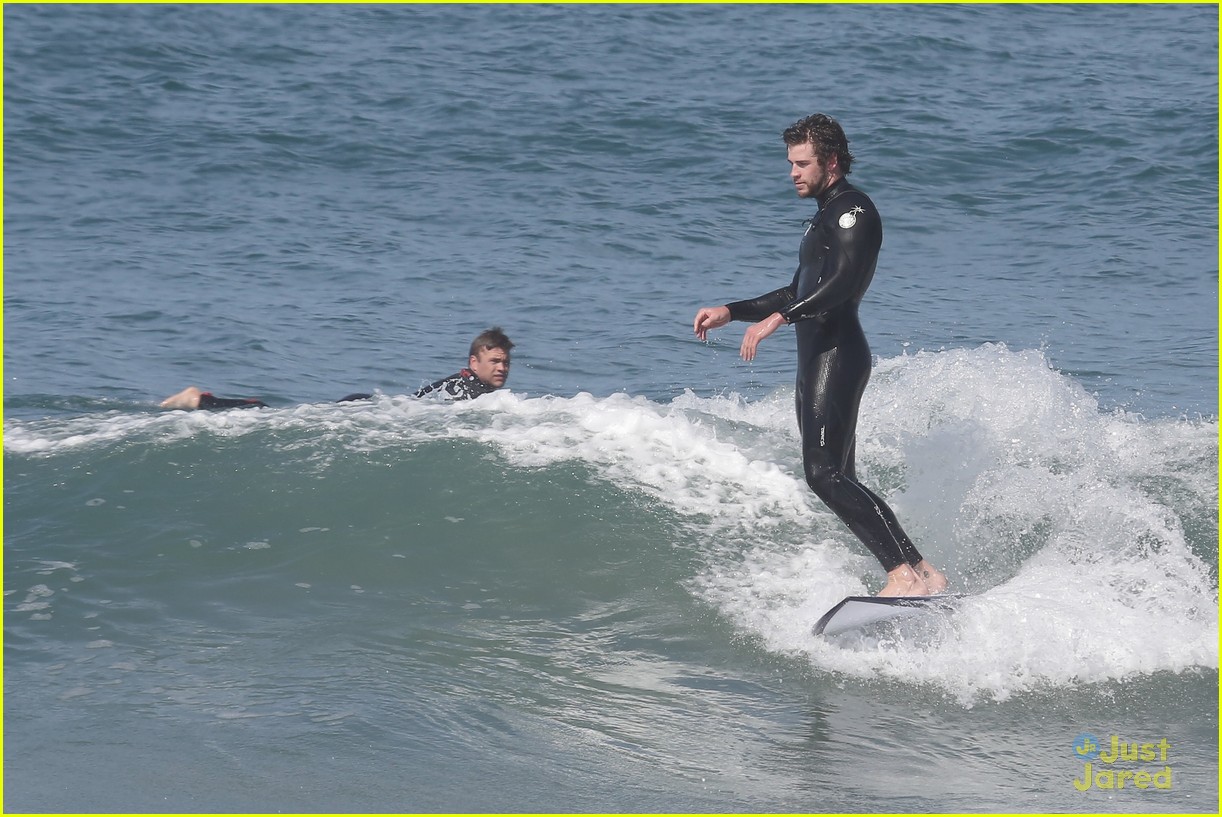 liam hemsworth surfs the waves with his brother luke11