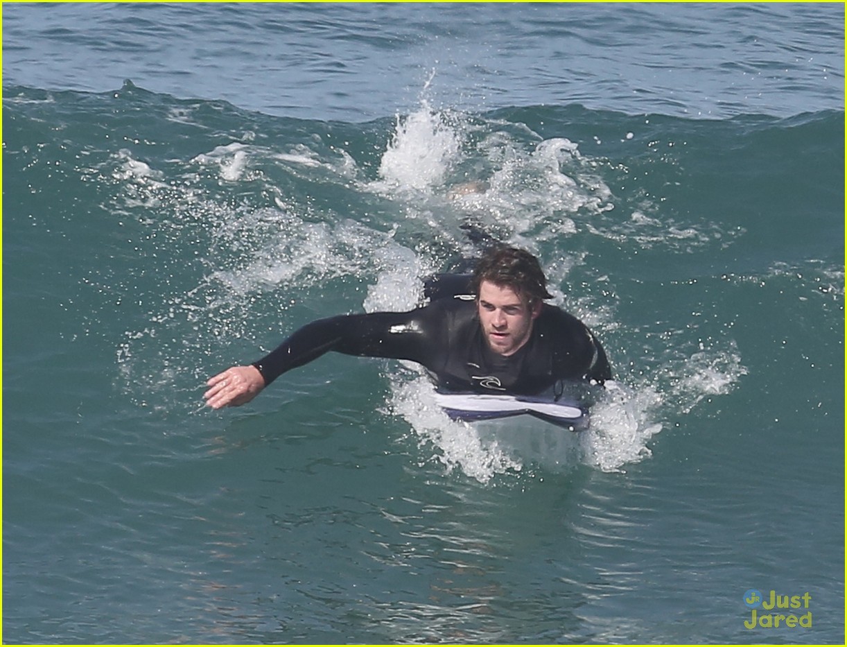 liam hemsworth surfs the waves with his brother luke18