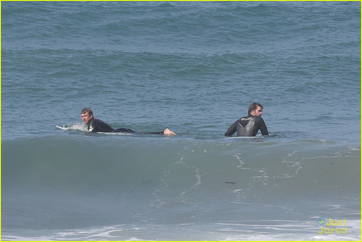 liam hemsworth surfs the waves with his brother luke20