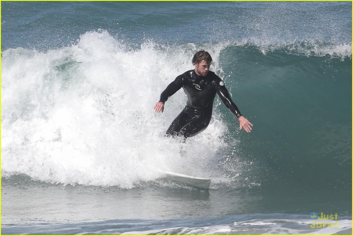 liam hemsworth surfs the waves with his brother luke22