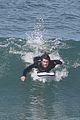 liam hemsworth surfs the waves with his brother luke17