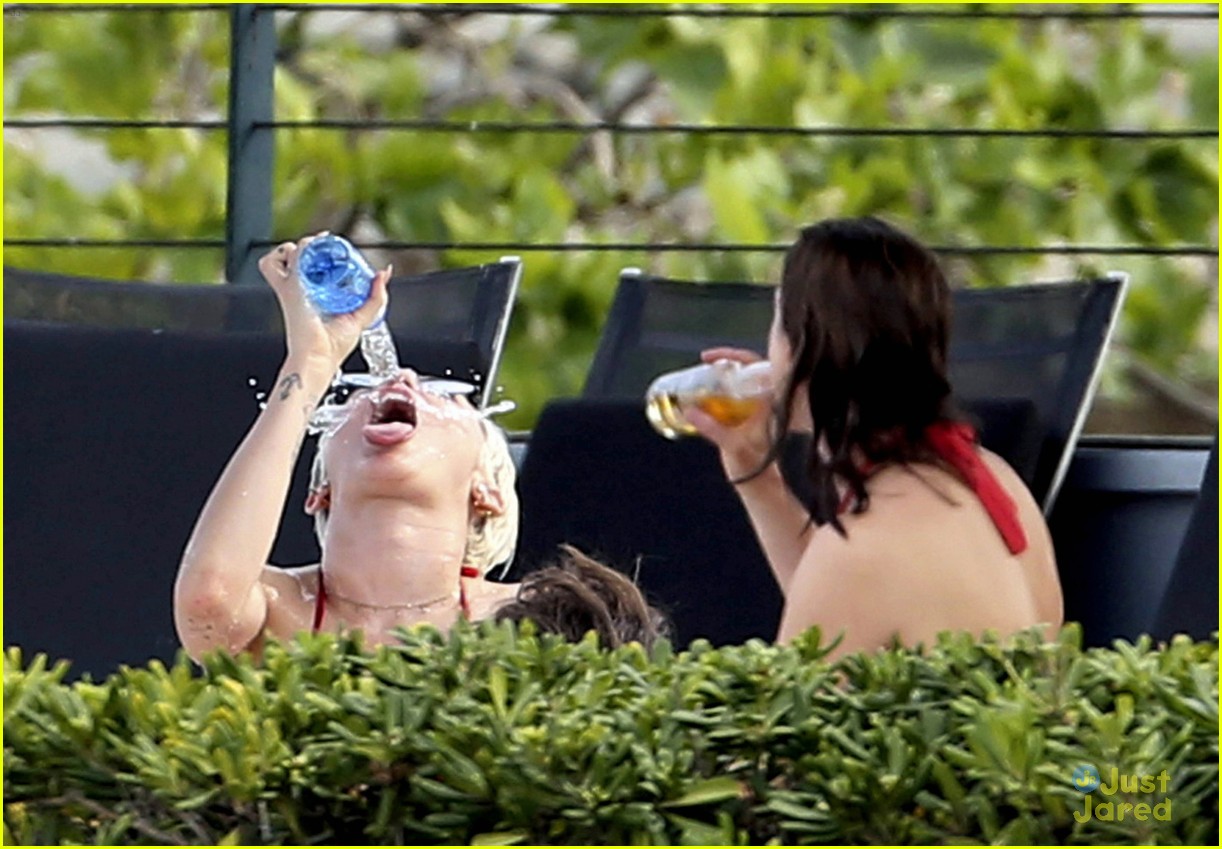 miley cyrus wears a bikini douses herself with water 02