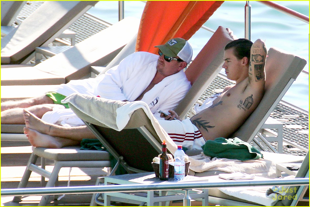 harry styles shirtless ponytail pool italy 09