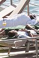 harry styles shirtless ponytail pool italy 24