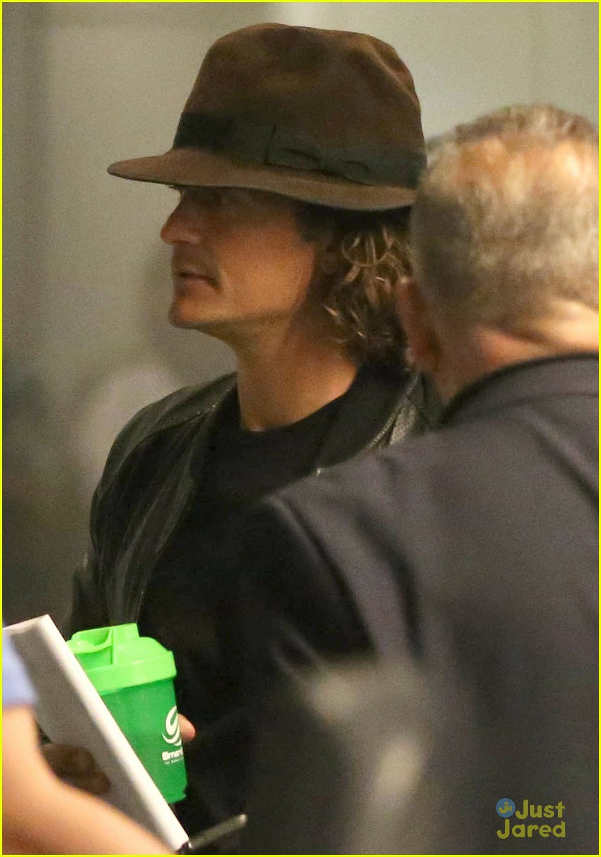 orlando bloom selena gomez walks steps apart from each other at the airport 05