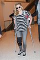chloe moretz knee brace crutches lax arrival 01