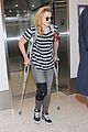 chloe moretz knee brace crutches lax arrival 10