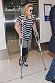 chloe moretz knee brace crutches lax arrival 15