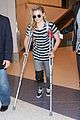 chloe moretz knee brace crutches lax arrival 19