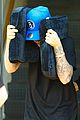 justin bieber covers hair with two cushions after salon visit 01