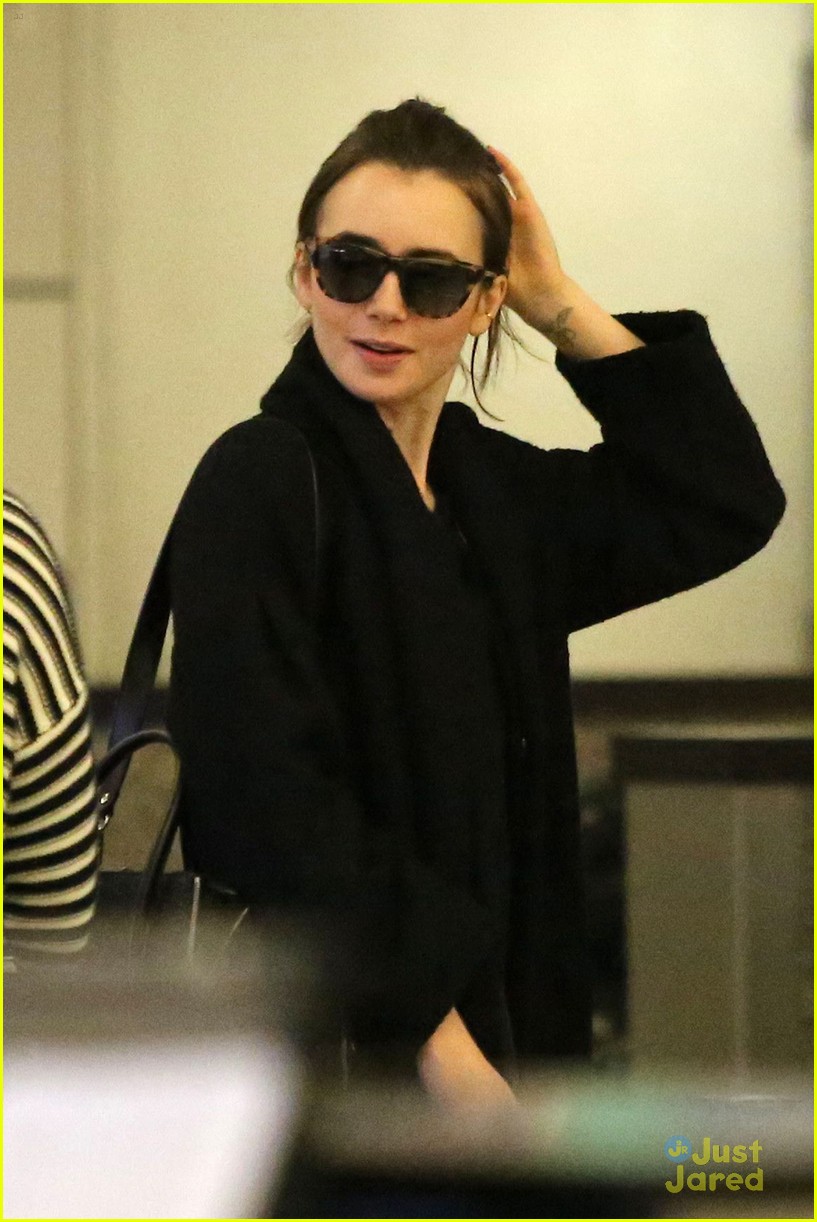 lily collins arrives lax after quick trip 04