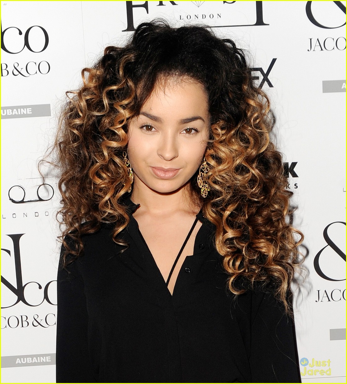 ella eyre looks her earrings over her face 03