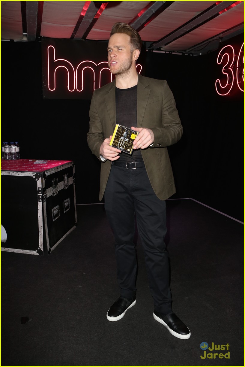 olly murs smirks while posing with special edition cd 13