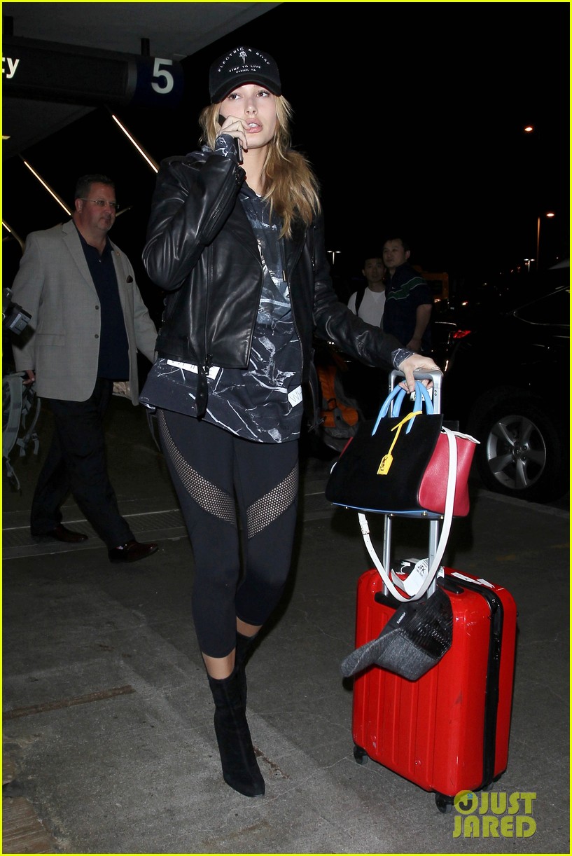 hailey baldwin pushes red carry on thru lax 13