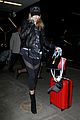 hailey baldwin pushes red carry on thru lax 20