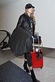 hailey baldwin pushes red carry on thru lax 23
