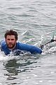 liam hemsworth strips out of his wetsuit after a surfing session 09