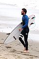 liam hemsworth strips out of his wetsuit after a surfing session 23