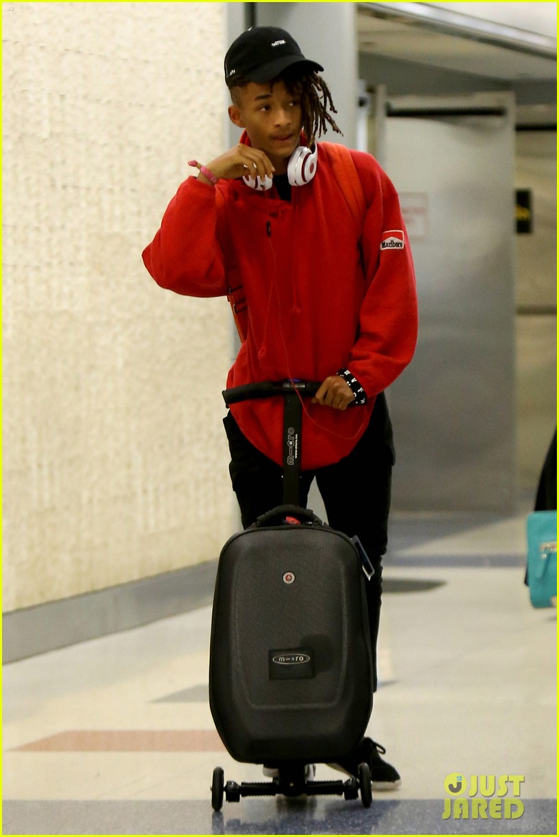 jaden smith rides luggage through airport 01