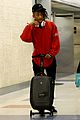 jaden smith rides luggage through airport 01