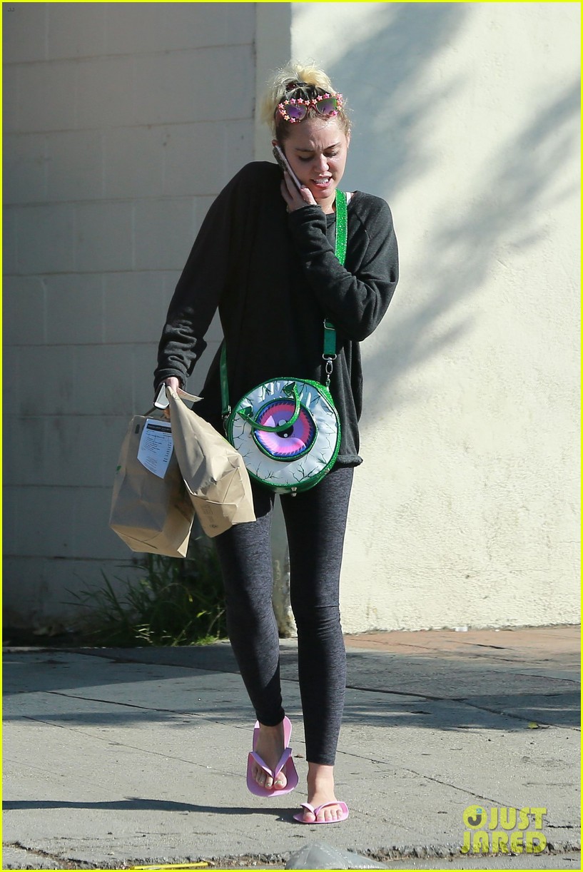 miley cyrus strips off her sweater for a visit to the nail salon 08