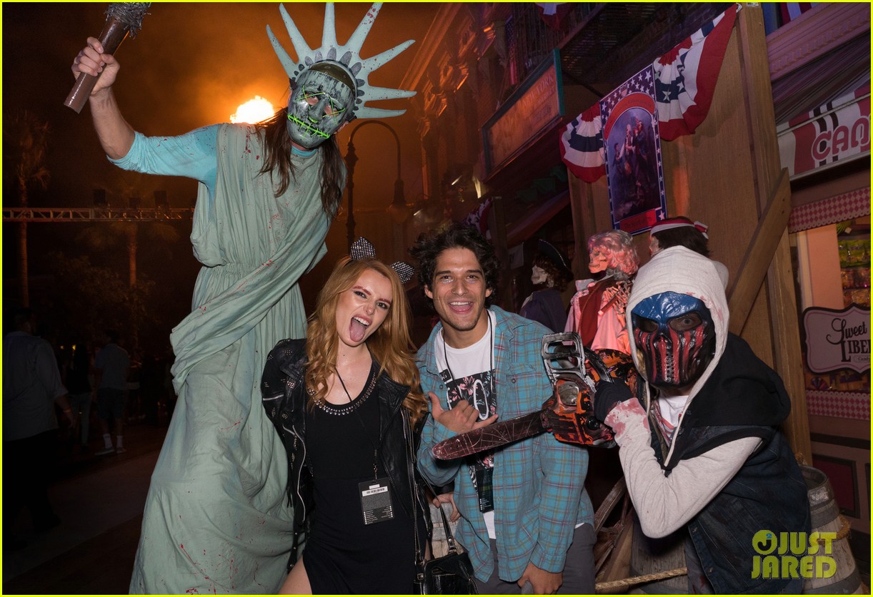bella thorne tyler posey couple up at halloween horror nights 01