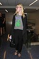 elle fanning brings back the 90s while heading to her flight 09