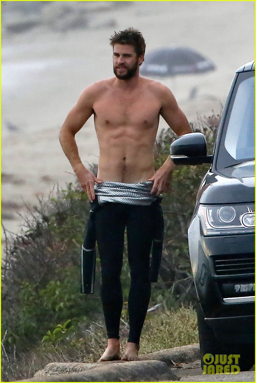 liam hemsworth bares his ripped abs while stripping out of wetsuit 10