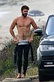 liam hemsworth bares his ripped abs while stripping out of wetsuit 01