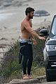 liam hemsworth bares his ripped abs while stripping out of wetsuit 03