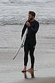 liam hemsworth bares his ripped abs while stripping out of wetsuit 05
