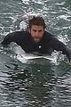 liam hemsworth bares his ripped abs while stripping out of wetsuit 15