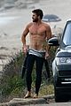 liam hemsworth bares his ripped abs while stripping out of wetsuit 17
