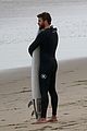 liam hemsworth bares his ripped abs while stripping out of wetsuit 20