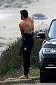 liam hemsworth bares his ripped abs while stripping out of wetsuit 21