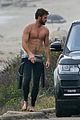 liam hemsworth bares his ripped abs while stripping out of wetsuit 25