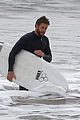 liam hemsworth bares his ripped abs while stripping out of wetsuit 26