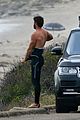 liam hemsworth bares his ripped abs while stripping out of wetsuit 34