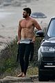 liam hemsworth bares his ripped abs while stripping out of wetsuit 35